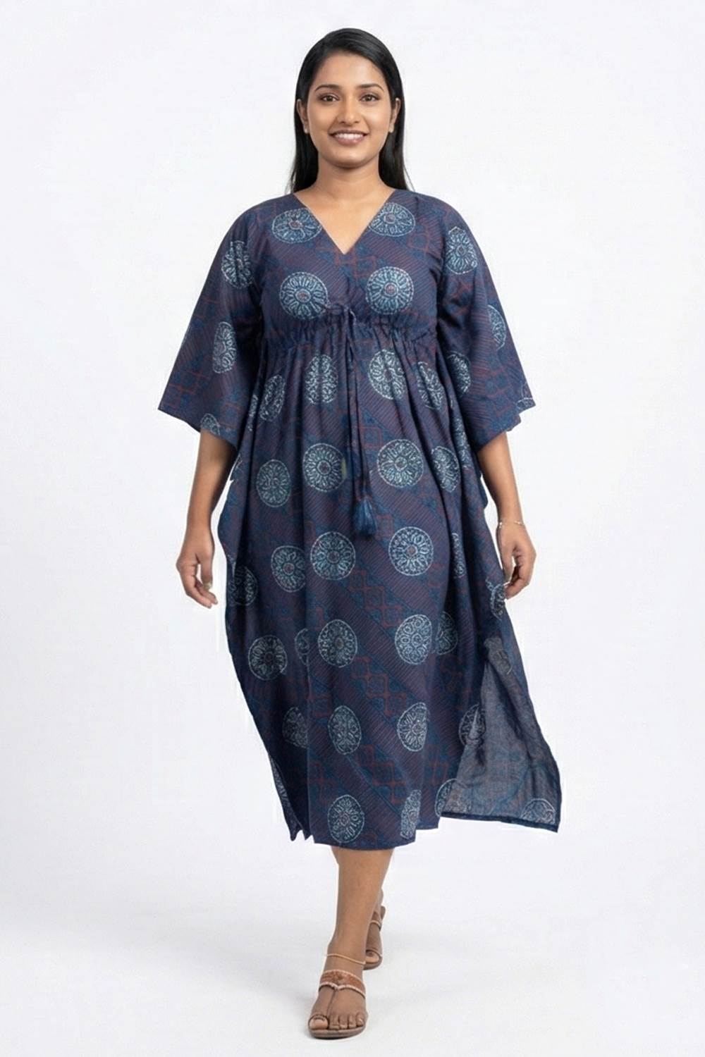 Woman wearing a navy blue patterned dress on a white background