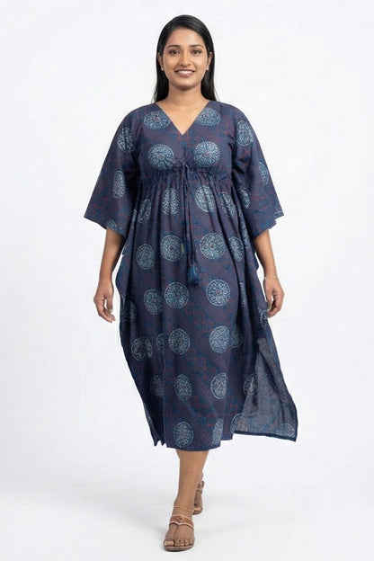 Woman wearing a navy blue patterned dress on a white background
