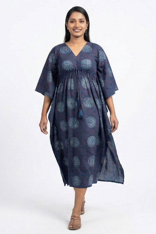 Woman wearing a navy blue patterned dress on a white background